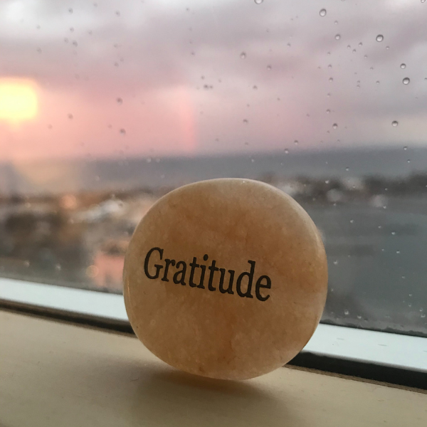 pink Quartz rock with the word Gratitude printed on it
